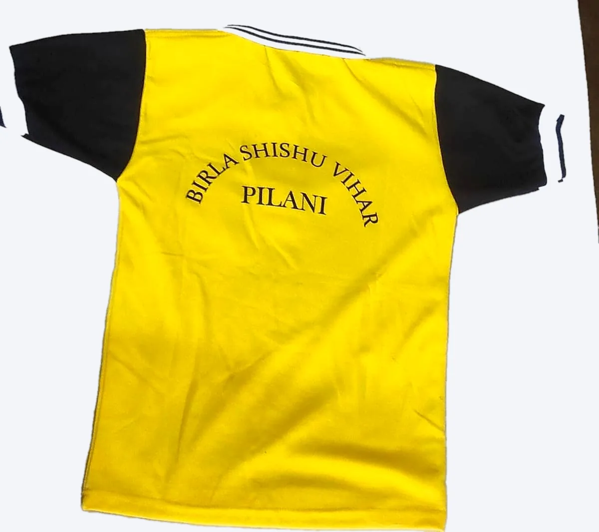 Back view — the school name embroidered, not printed on